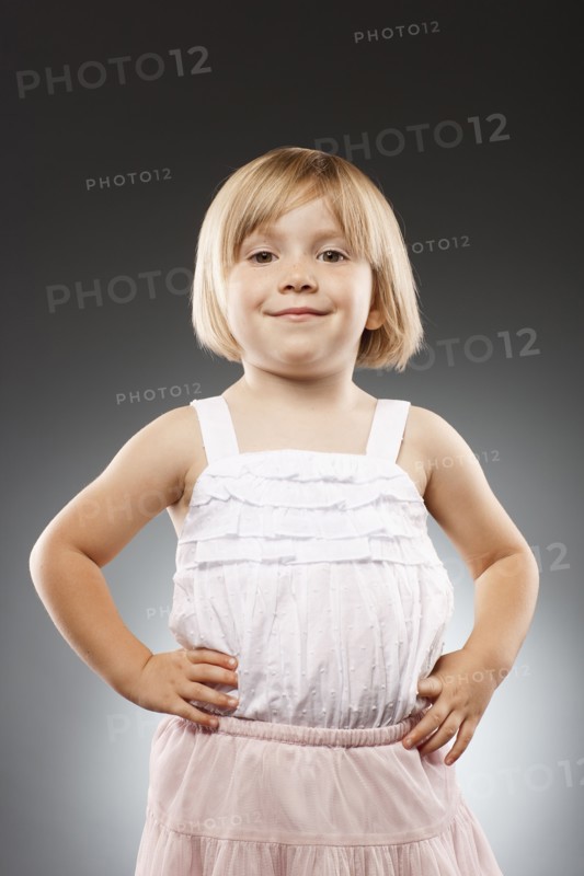 Girl (2-3) with hands on hip and looking at camera, studio shot. Photo : FBP