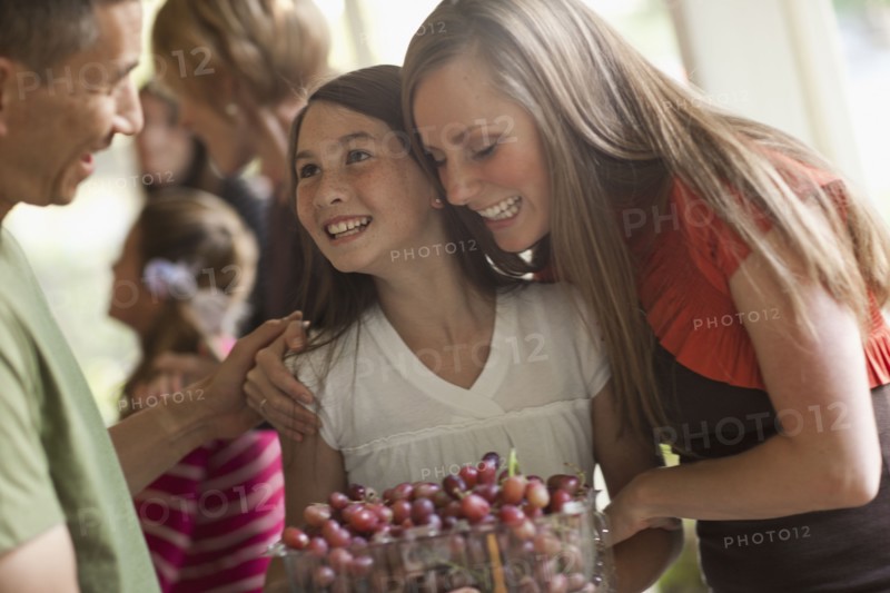 Girl (10 -11,) with family during celebration event. Photo : Tim Pannell