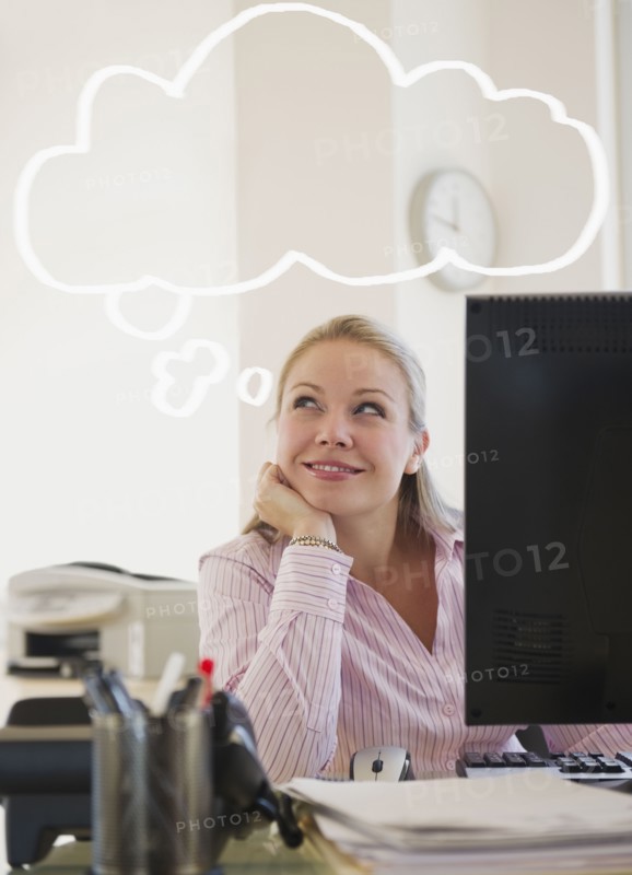 USA, New Jersey, Jersey City, Young attractive businesswoman daydreaming in office. Photo : Jamie Grill Photography