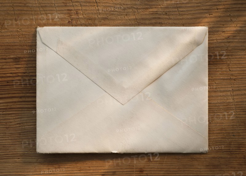 Blank envelope on wooden table.
