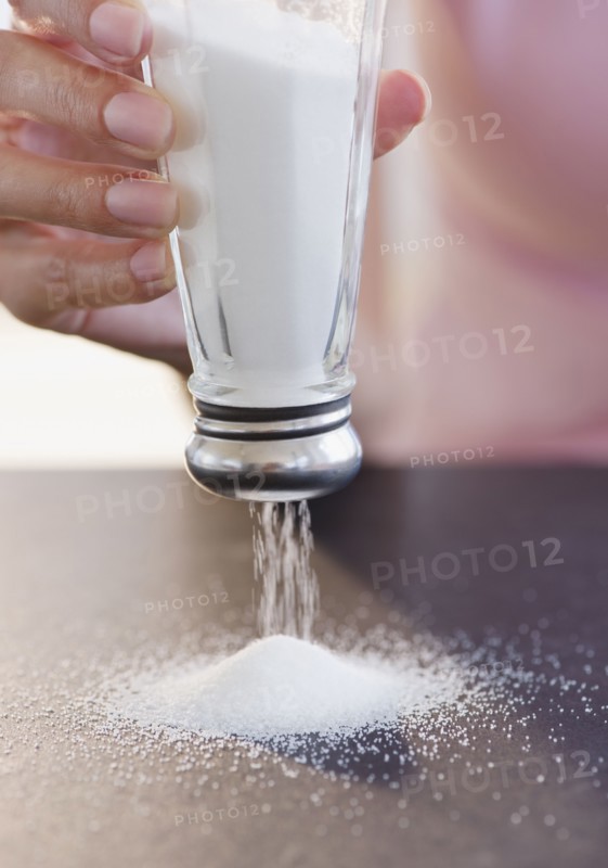 USA, New Jersey, Jersey City, Woman hand holding salt shaker upside down. Photo : Jamie Grill Photography