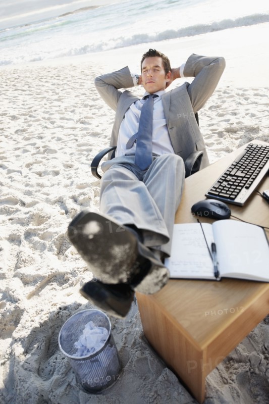 South Africa, Businessman relaxing on beach. Photo : momentimages