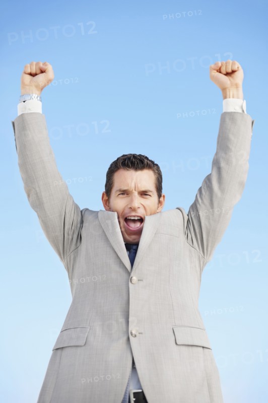 South Africa, Happy businessman, low angle view. Photo : momentimages