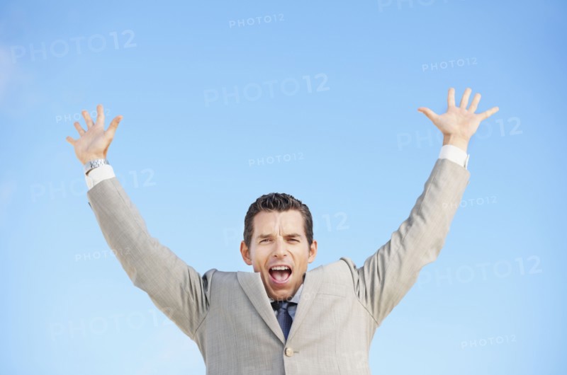 South Africa, Happy businessman, low angle view. Photo : momentimages