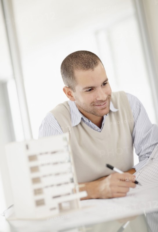 South Africa, Smiling architect working in office. Photo : momentimages