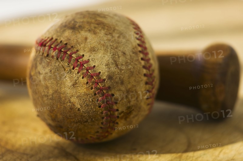 Antique baseball with baseball bat.