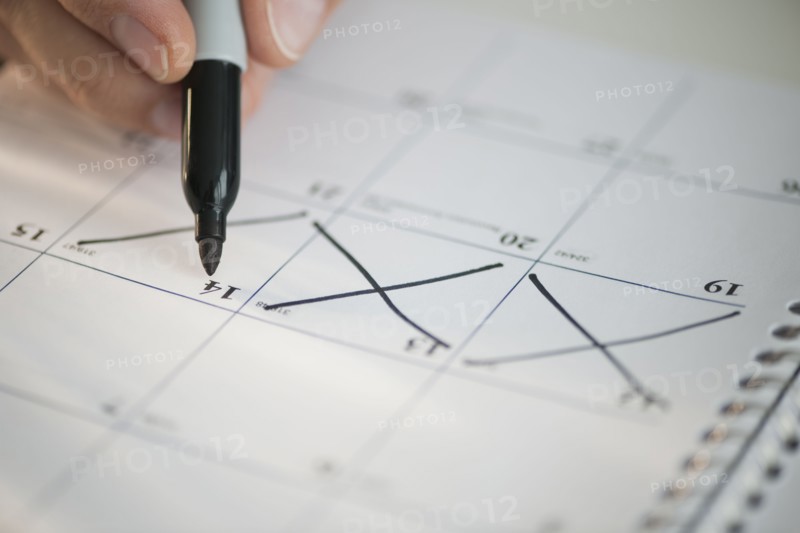 USA, New Jersey, Jersey City, Man writing on calendar.