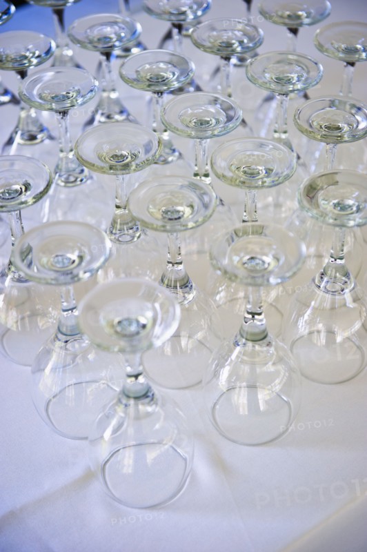 Rows of wine glasses on table .