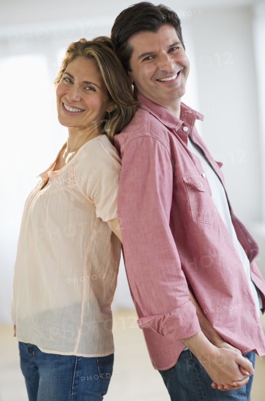 USA, New Jersey, Jersey City, Portrait of couple standing back to back.