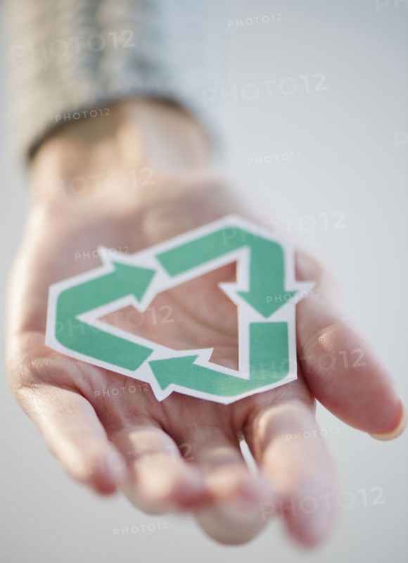 USA, New Jersey, Jersey City, Woman's hand holding recycling symbol. Photo : Jamie Grill Photography