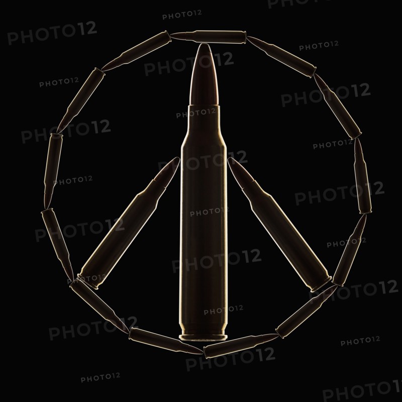 Peace Sign made of bullets on black background. Photo : Mike Kemp