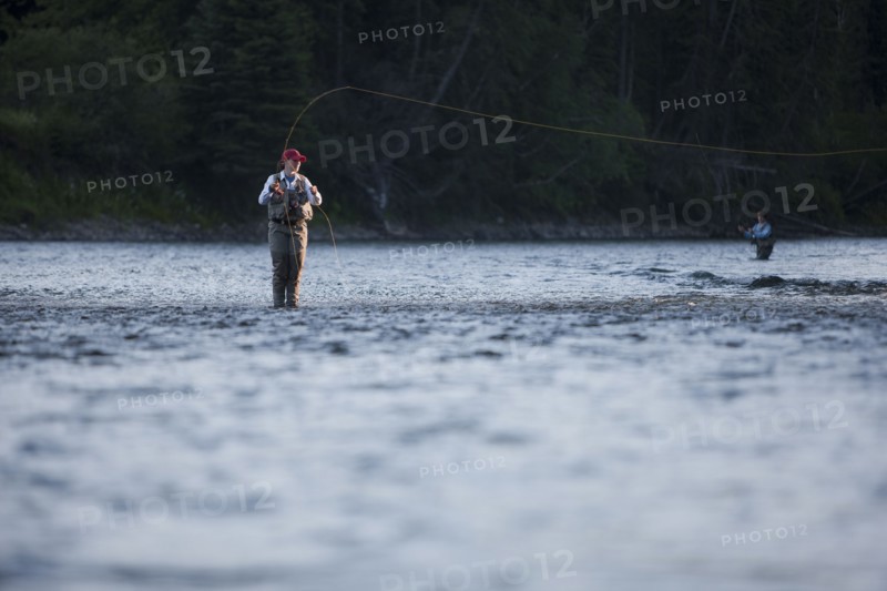 Canada, British Columbia, Fernie, Woman fly fishing in river. Photo : Dan Bannister