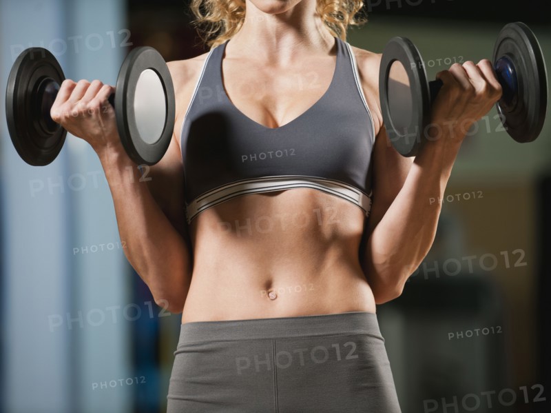 USA, California, Los Angeles, woman exercising with dumbbells.