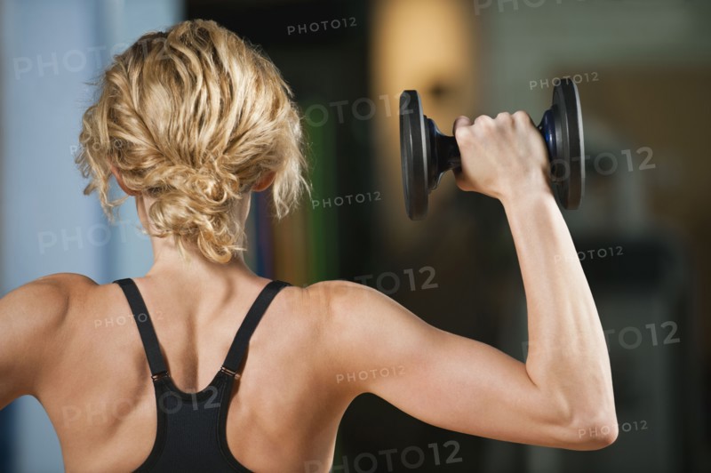 USA, California, Los Angeles, woman exercising with dumbbells.