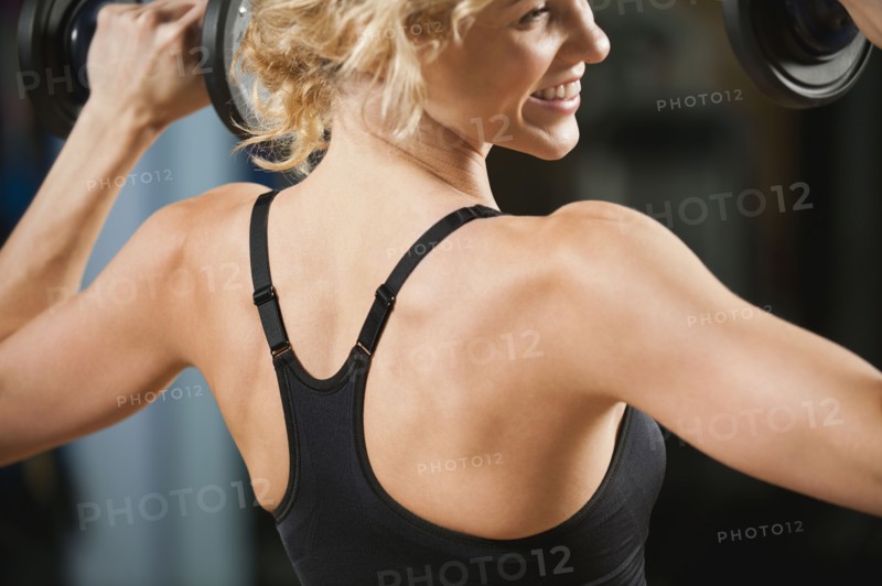 USA, California, Los Angeles, woman exercising with dumbbells.
