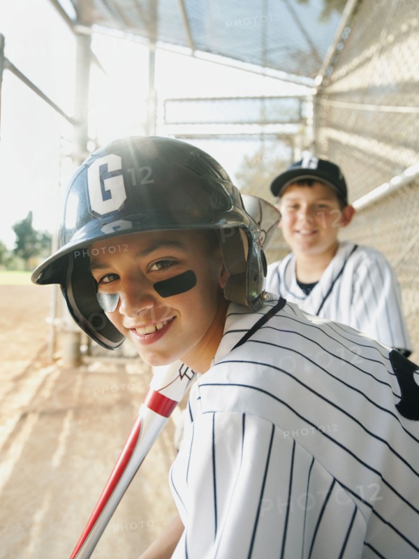 USA, California, Ladera Ranch, boys (10-11) from little league baseball team on dugout.