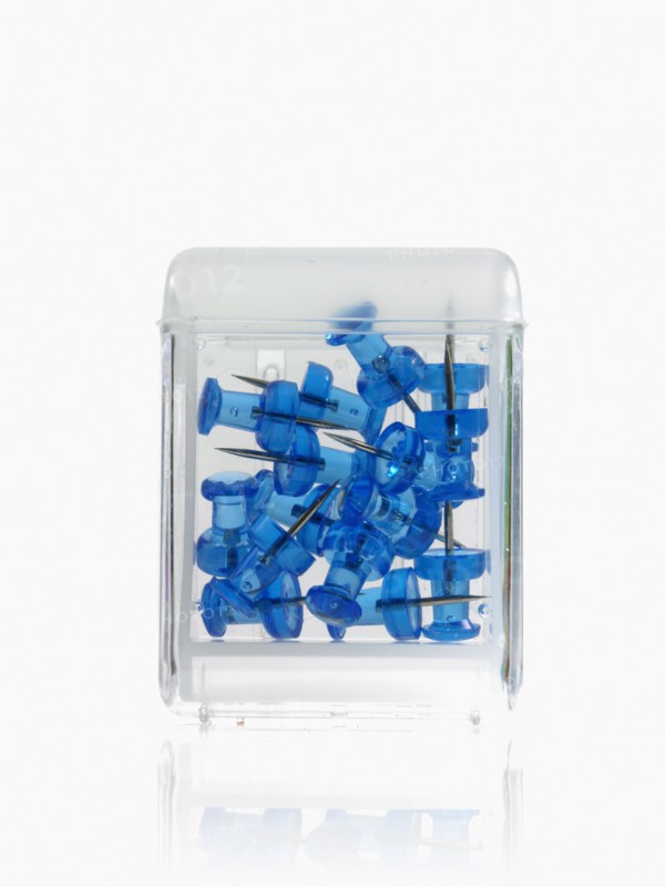 Studio shot of blue thumbtacks in glass cube. Photo : David Arky