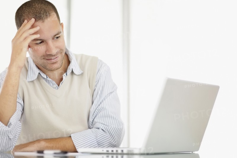 South Africa, Portrait of young man with laptop. Photo : momentimages