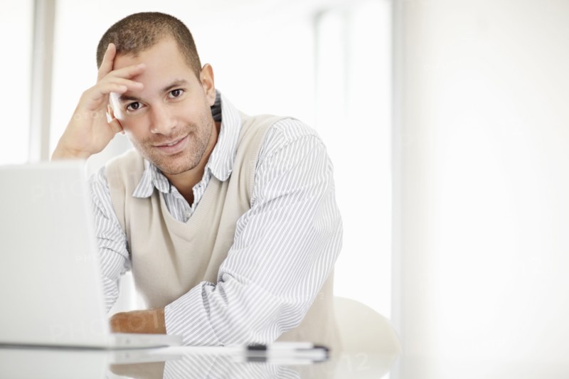 South Africa, Portrait of young man with laptop. Photo : momentimages