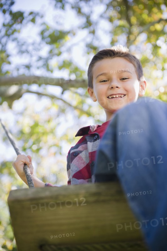 USA, New York, Flanders, Boy (8-9) playing in garden. Photo : Jamie Grill Photography