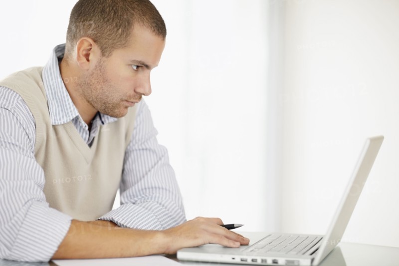 South Africa, Portrait of young man with laptop. Photo : momentimages