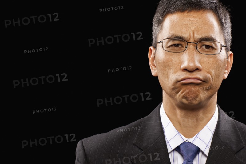 Studio portrait of sulking businessman. Photo : FBP