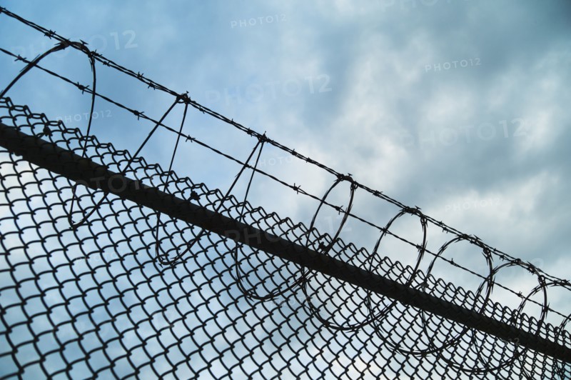 USA, New York, New York City, Barbed wire fence.
