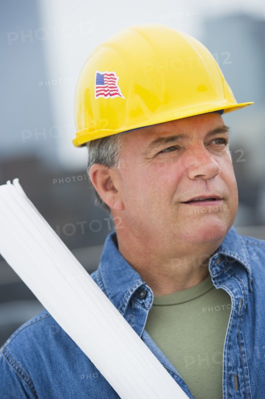 USA, New Jersey, Jersey City, Construction worker holding blueprints on construction site.