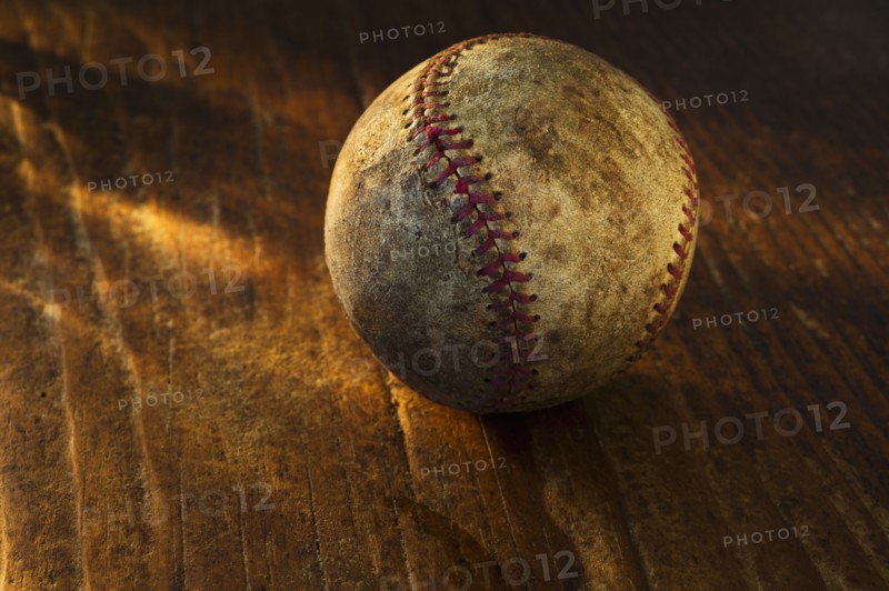 Antique baseball on wooden floor.