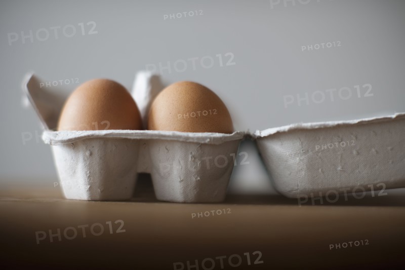 Eggs in egg carton on table, close-up.