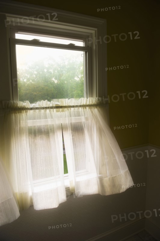 Wind blowing curtains through window.