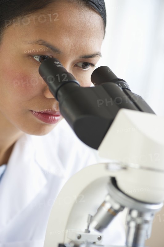 USA, New Jersey, Jersey City, Female scientist using microscope.