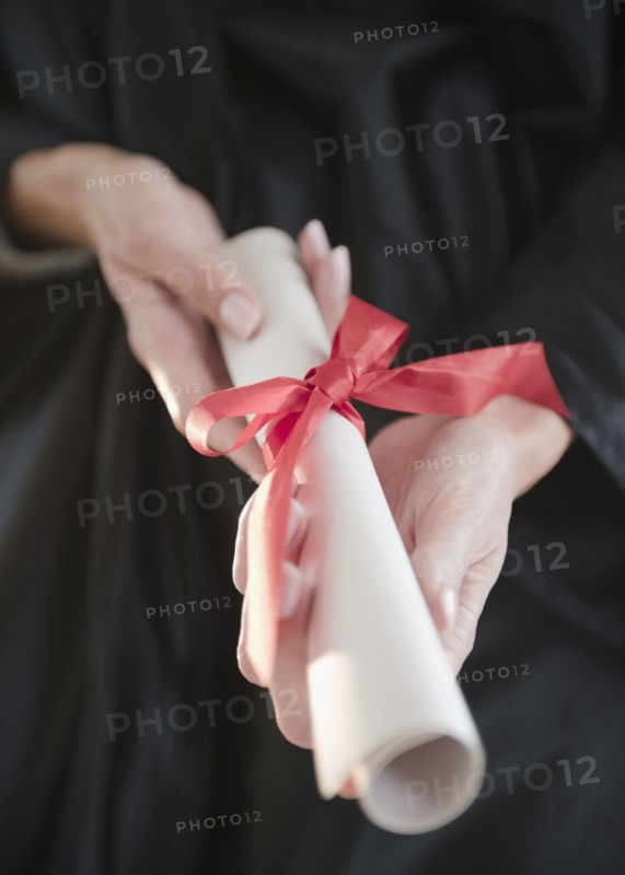 USA, New Jersey, Jersey City, Close-up view of woman hands holding diploma. Photo : Jamie Grill Photography