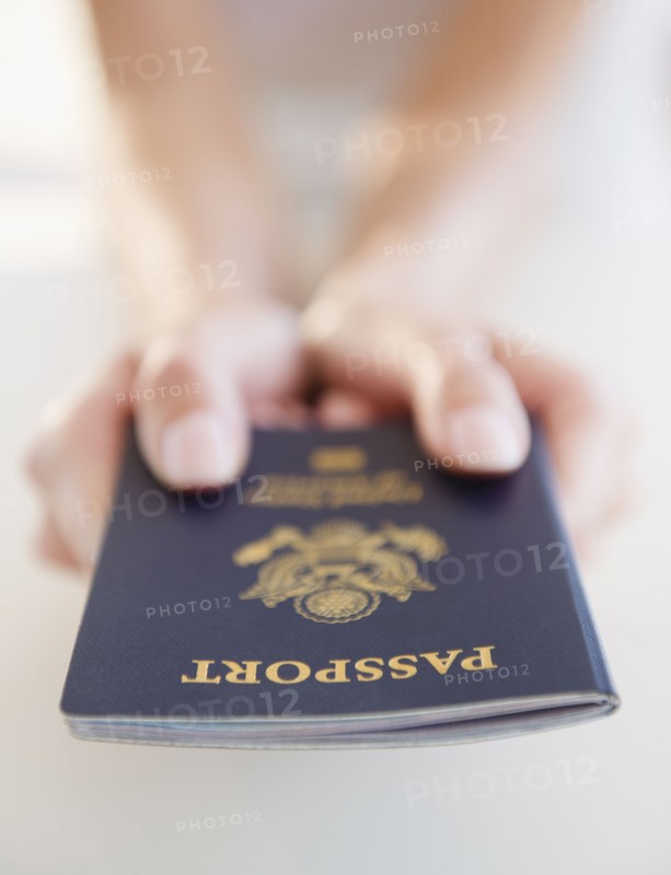 USA, New Jersey, Jersey City, Close-up view of woman's hands holding US passport. Photo : Jamie Grill Photography