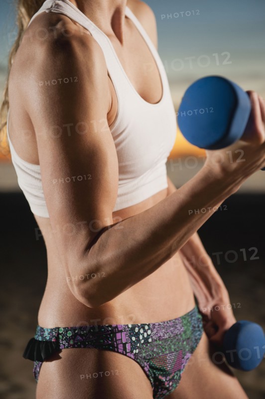 USA, California, Los Angeles, woman exercising with dumbbells.
