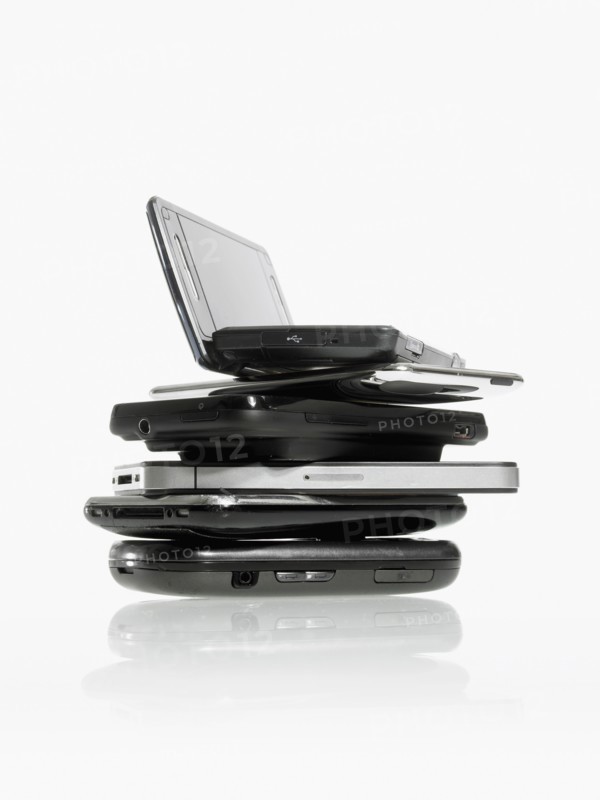 Studio shot of pile of laptops and palmtops. Photo : David Arky
