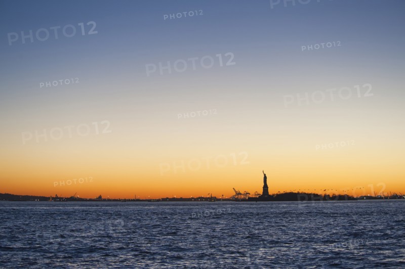 USA, New York City, Staten Island, Harbor and silhouette of Statue of Liberty in background.