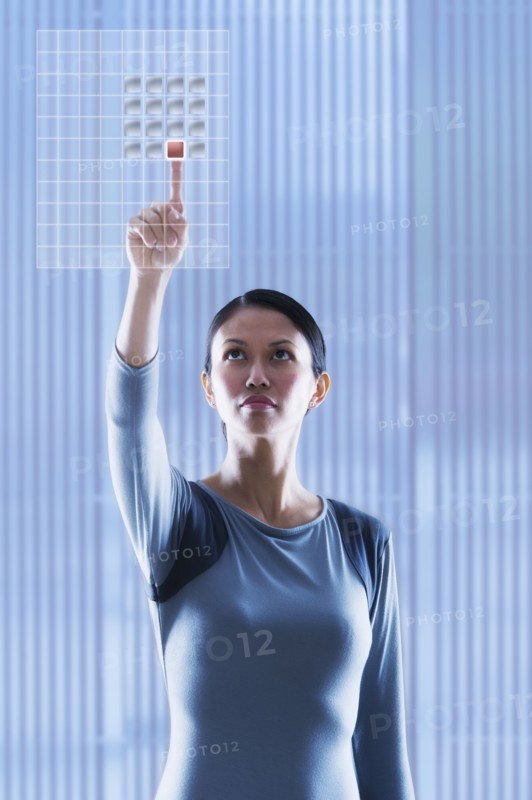 Woman touching glass panel.