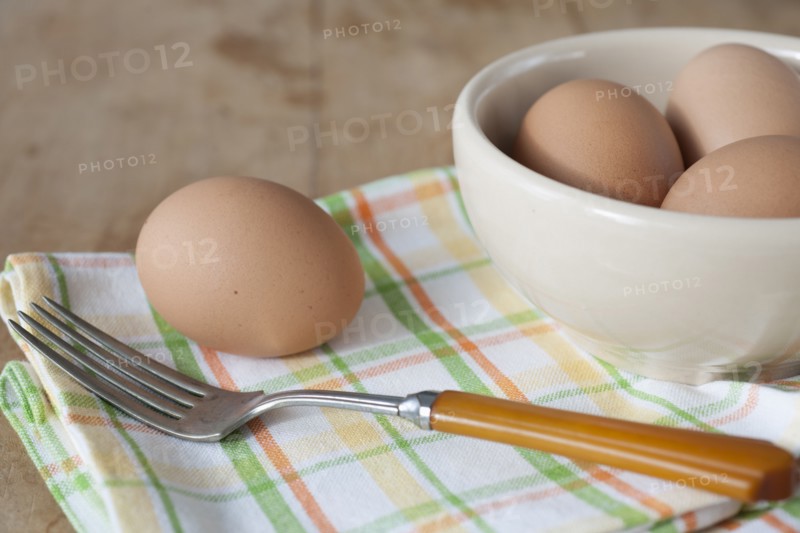 Bowl of boiled eggs with fork.