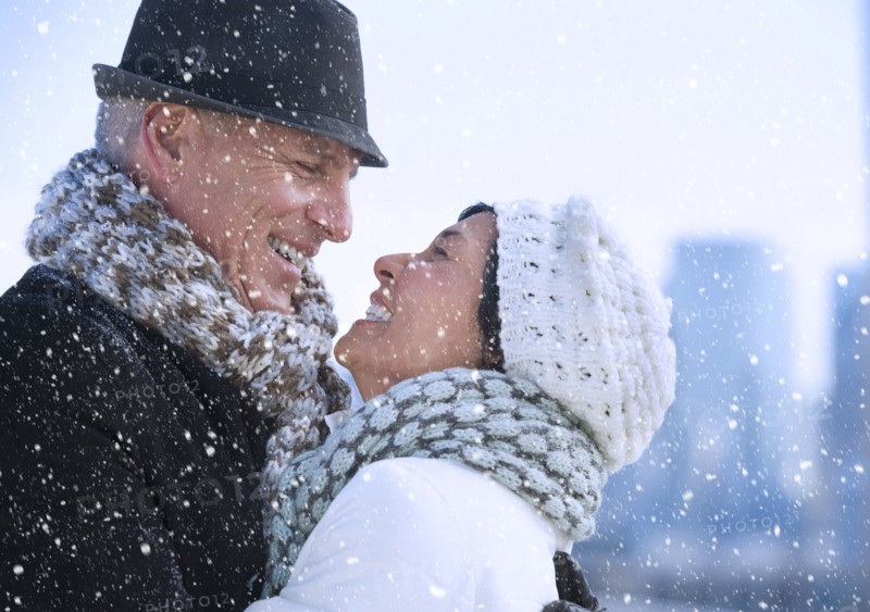 Happy mature couple in winter scenery.