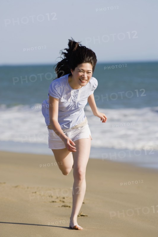 USA, California, Point Reyes, Young woman running on beach. Photo : Noah Clayton