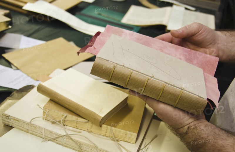 hands binding book.