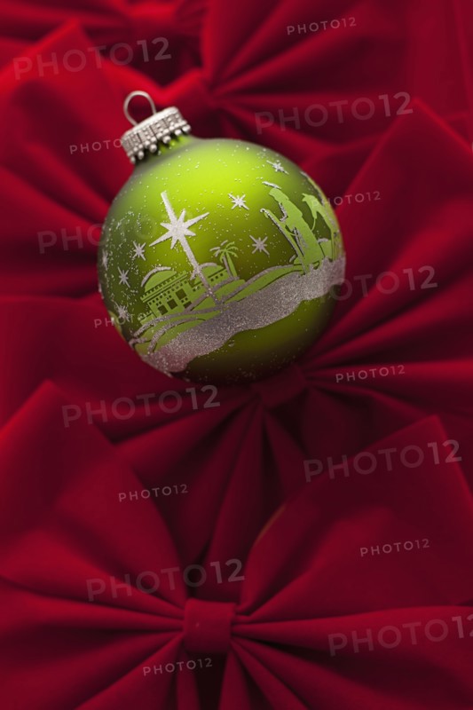 Studio Shot of red velvet bows with green Christmas ornament. Photo : Mike Kemp