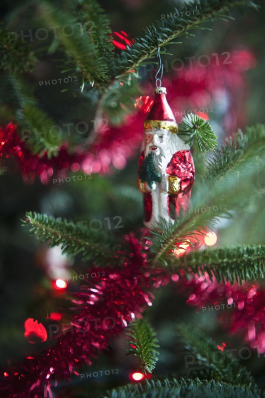 Santa Claus Christmas decoration hanging on Christmas tree, studio shot.