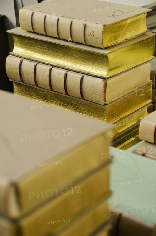 Books stacked in binding workshop.