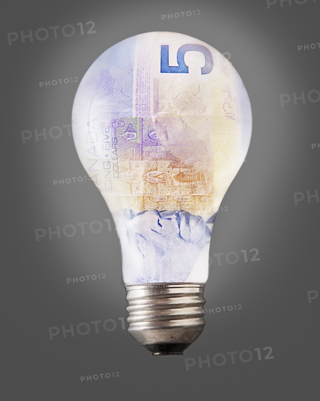 Composition of bulb and five canadian dollar banknote. Photo : Mike Kemp