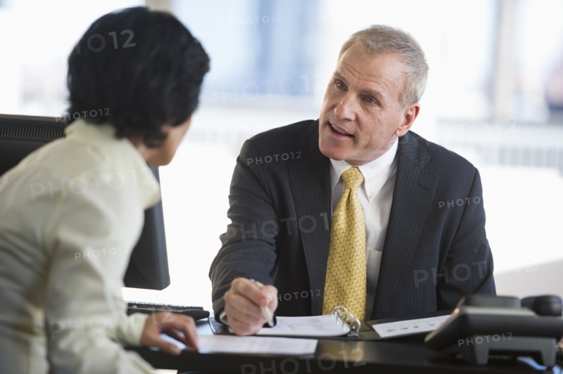 Businesswoman and businessman at meeting.