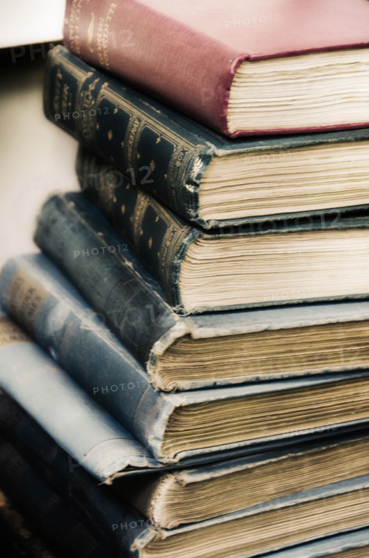 Close up stack of antique books .