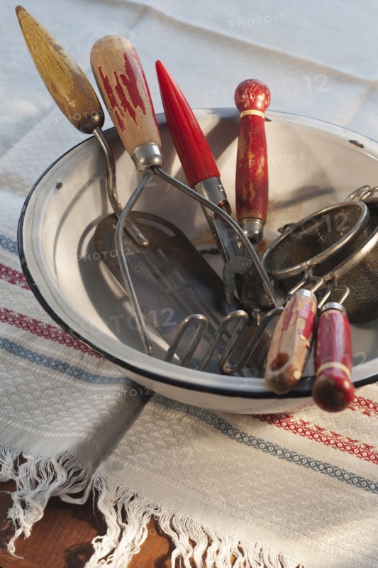 Antique cooking utensils in bowl.