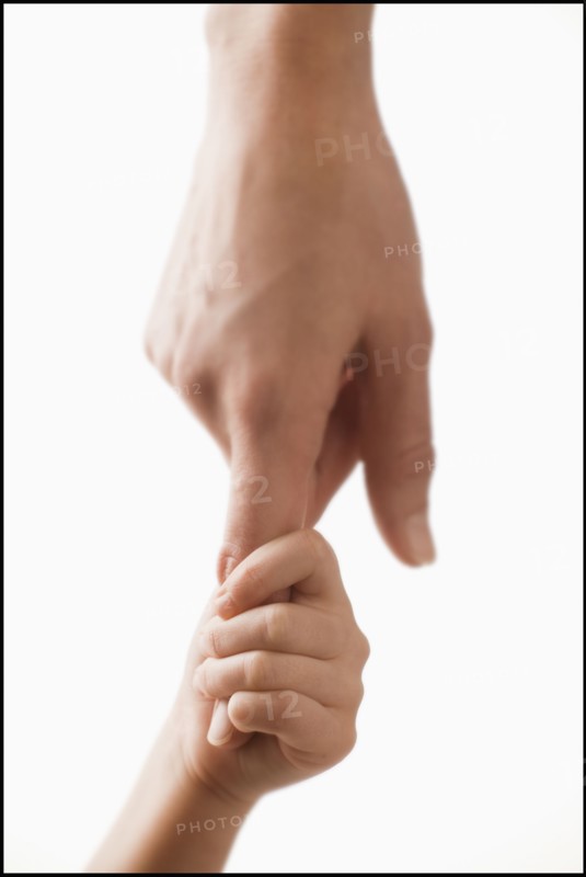 Studio shot of hands of woman and girl (2-3). Photo : Mike Kemp